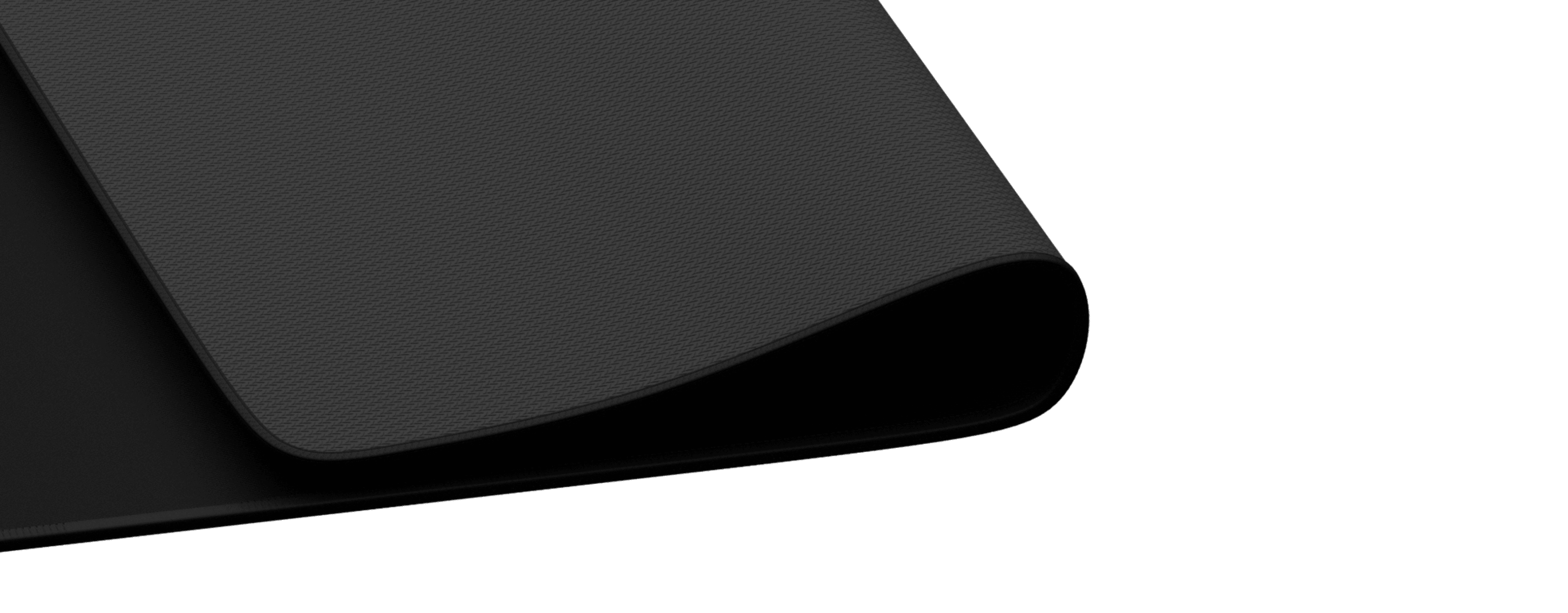 Zbliżenie czarnej podkładki pod mysz Genesis Carbon 700 XL z teksturowaną powierzchnią i lekko zawiniętymi krawędziami