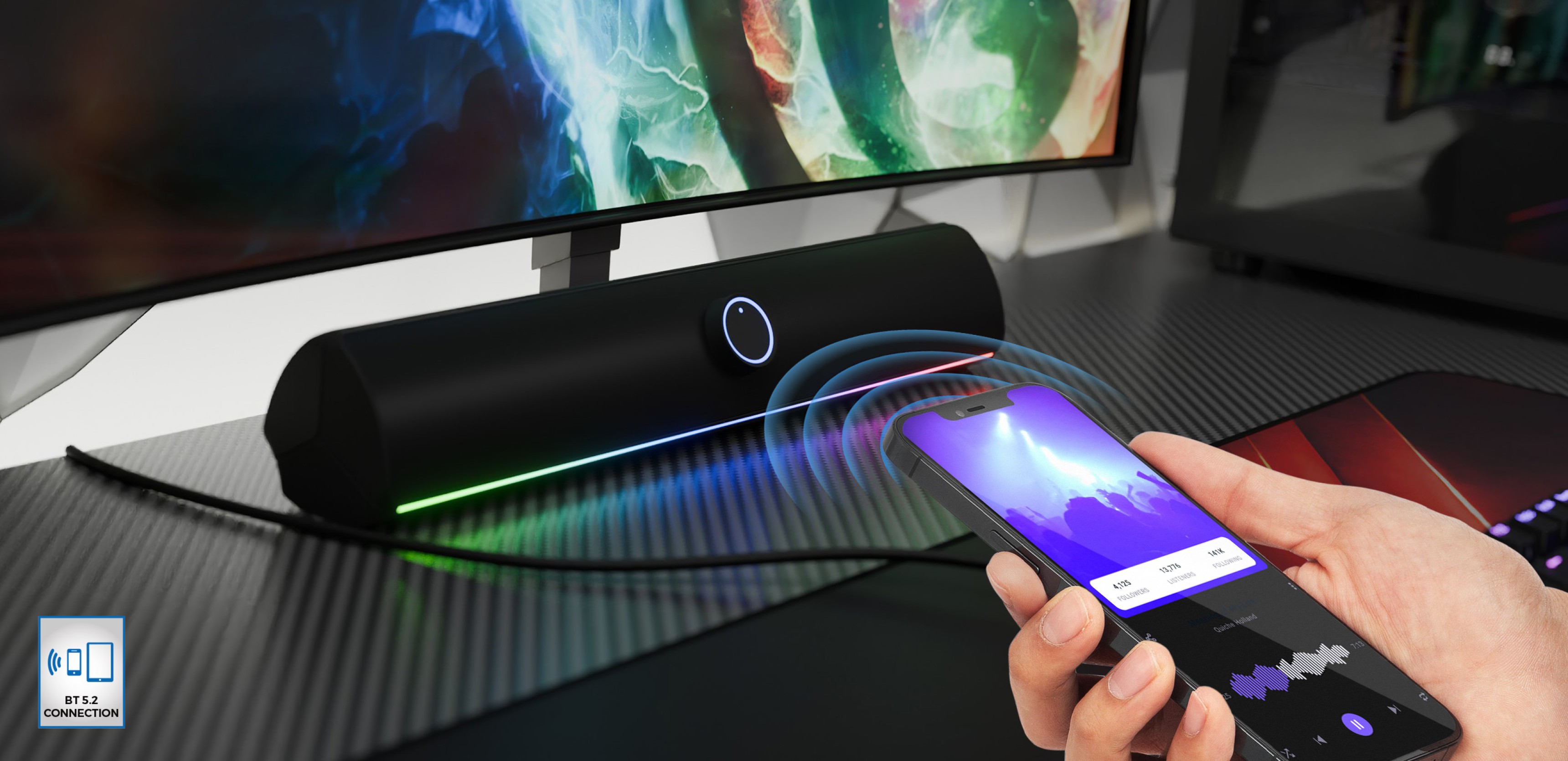 Soundbar Bluetooth w kolorze czarnym z oświetleniem LED, sterowany bezprzewodowo za pomocą smartfona na biurku